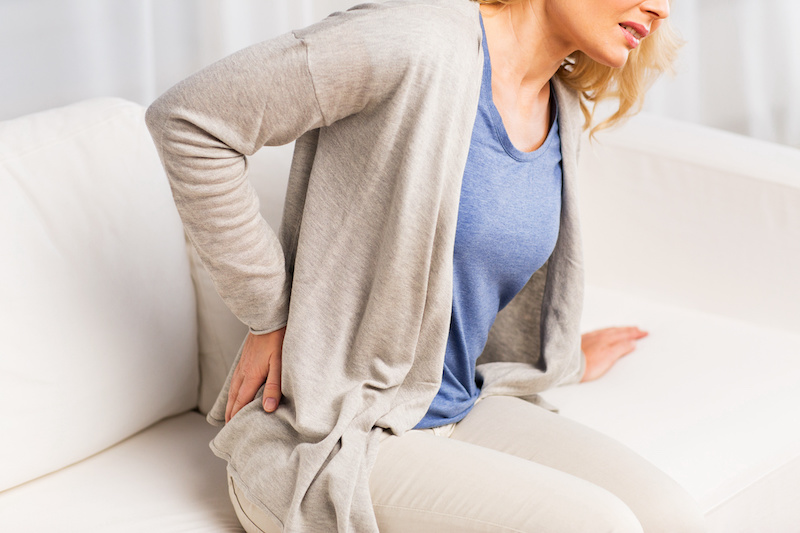 woman clutching her back in pain