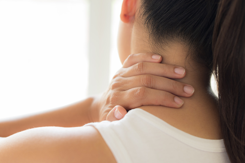 Cervical Artery Dissection woman touching her neck