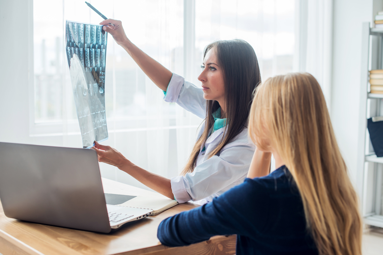 doctor examining MRI results with patient