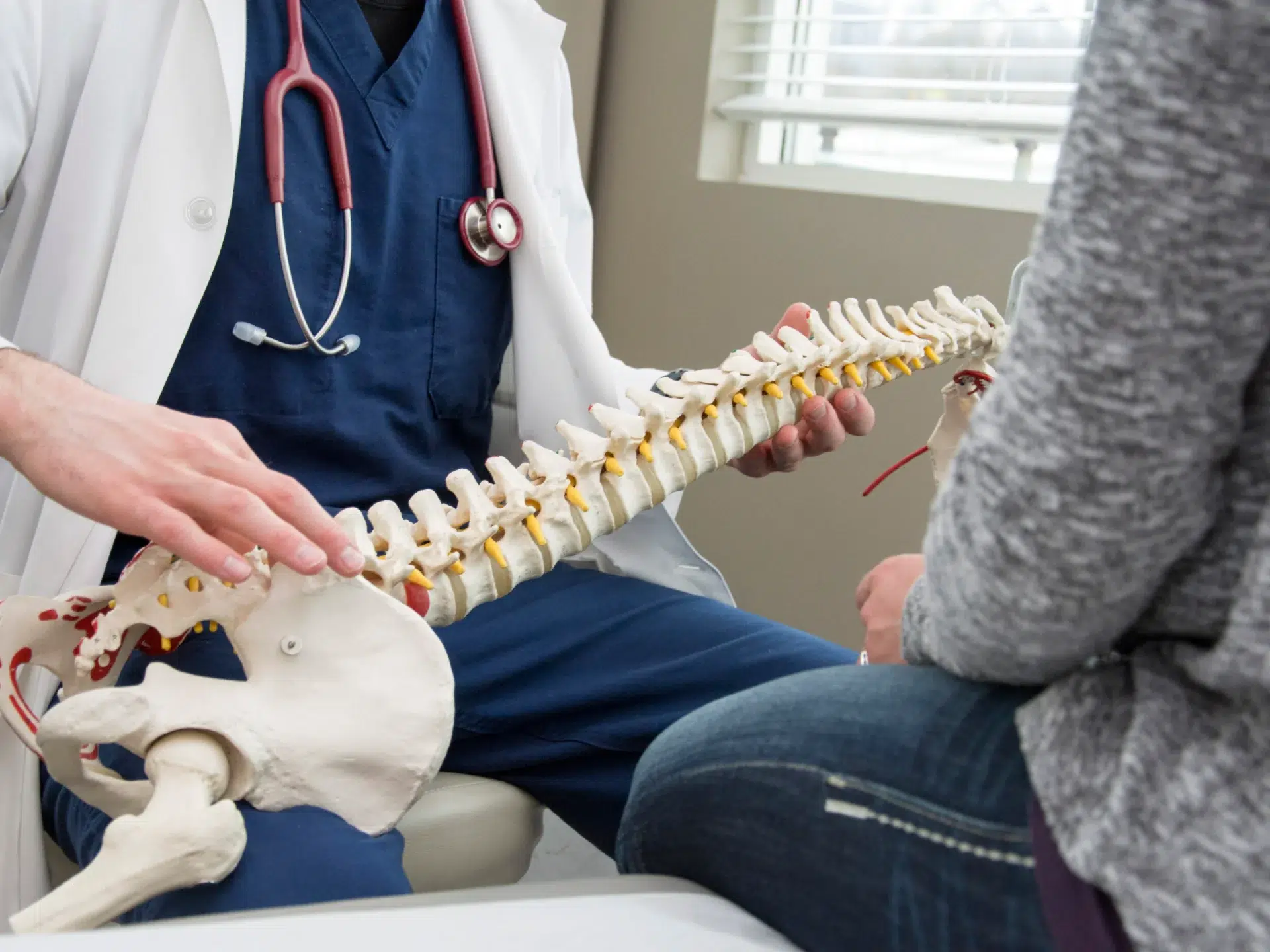 a doctor explaining the spine to his patient