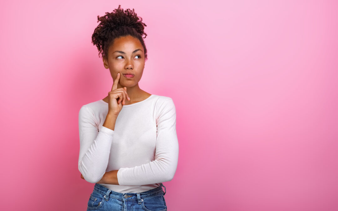 Studio portrait of a thinking pose girl touching herself face by index finger Image
